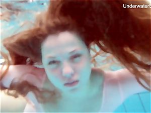 sandy-haired Simonna showcasing her assets underwater